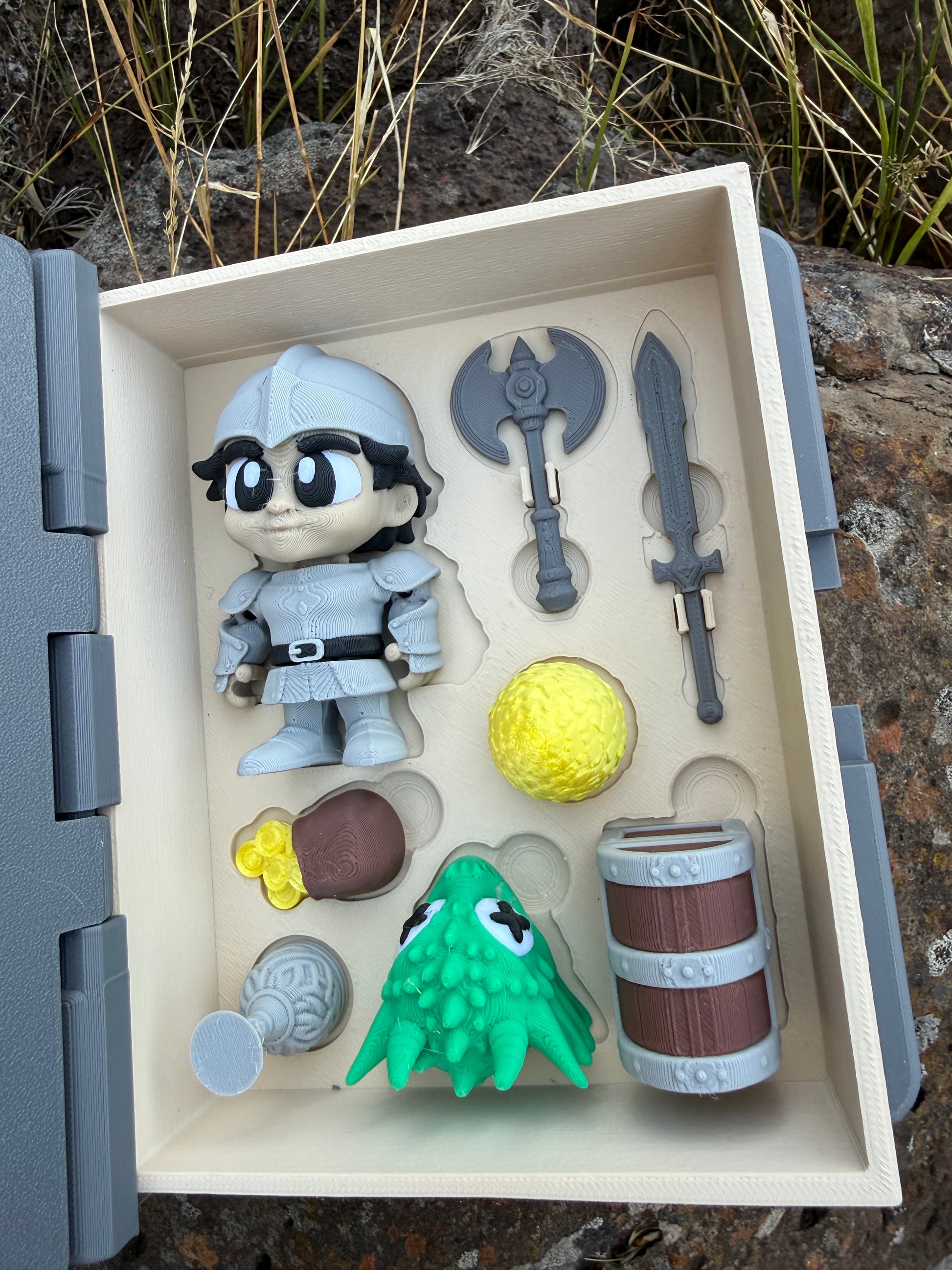 Toy figure set with accessories in a display case book outdoors