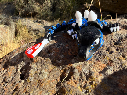 3D small printed raptor black and blue. large and small with steak detail tail. bone and egg details down their back