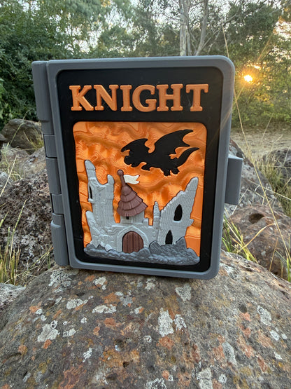 Decorative sign with 'KNIGHT' and castle design on a rock outdoors