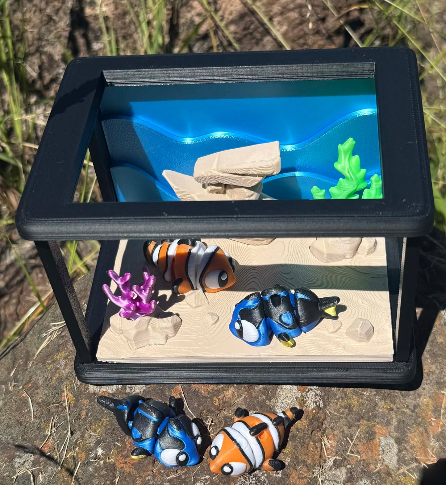 Small aquarium with fish and coral on a natural background
