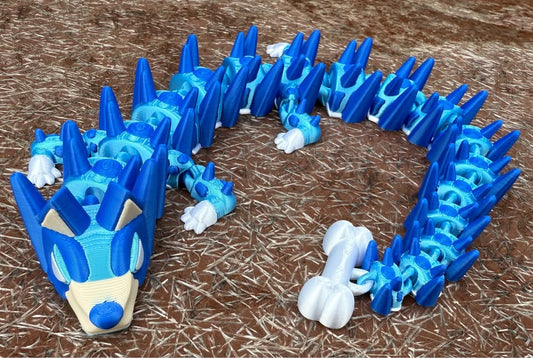 Blue 3d printed dog dragon on a brown textured surface