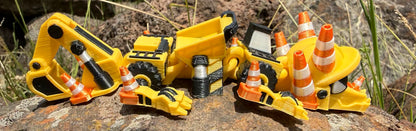 3D printed excavator mini dragon with traffic cones on a rocky surface