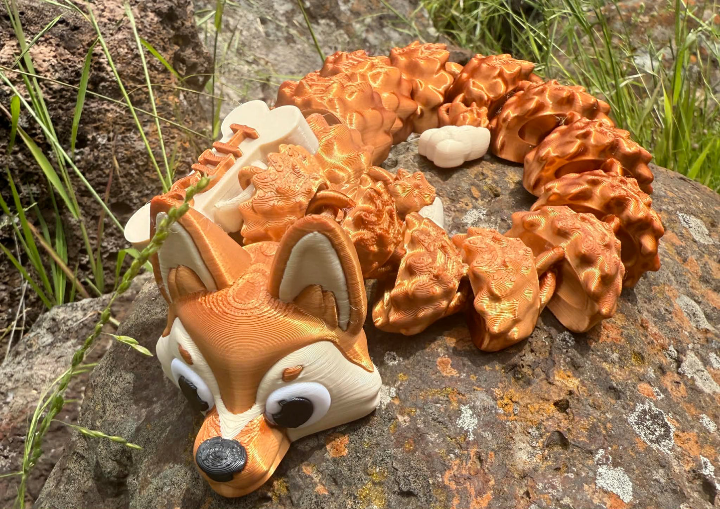 3d printed German Shepard dragon on a rocky surface